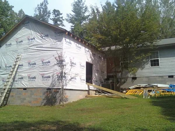 Tyvek wrapped gable on a new room addition beside an existing home in Check